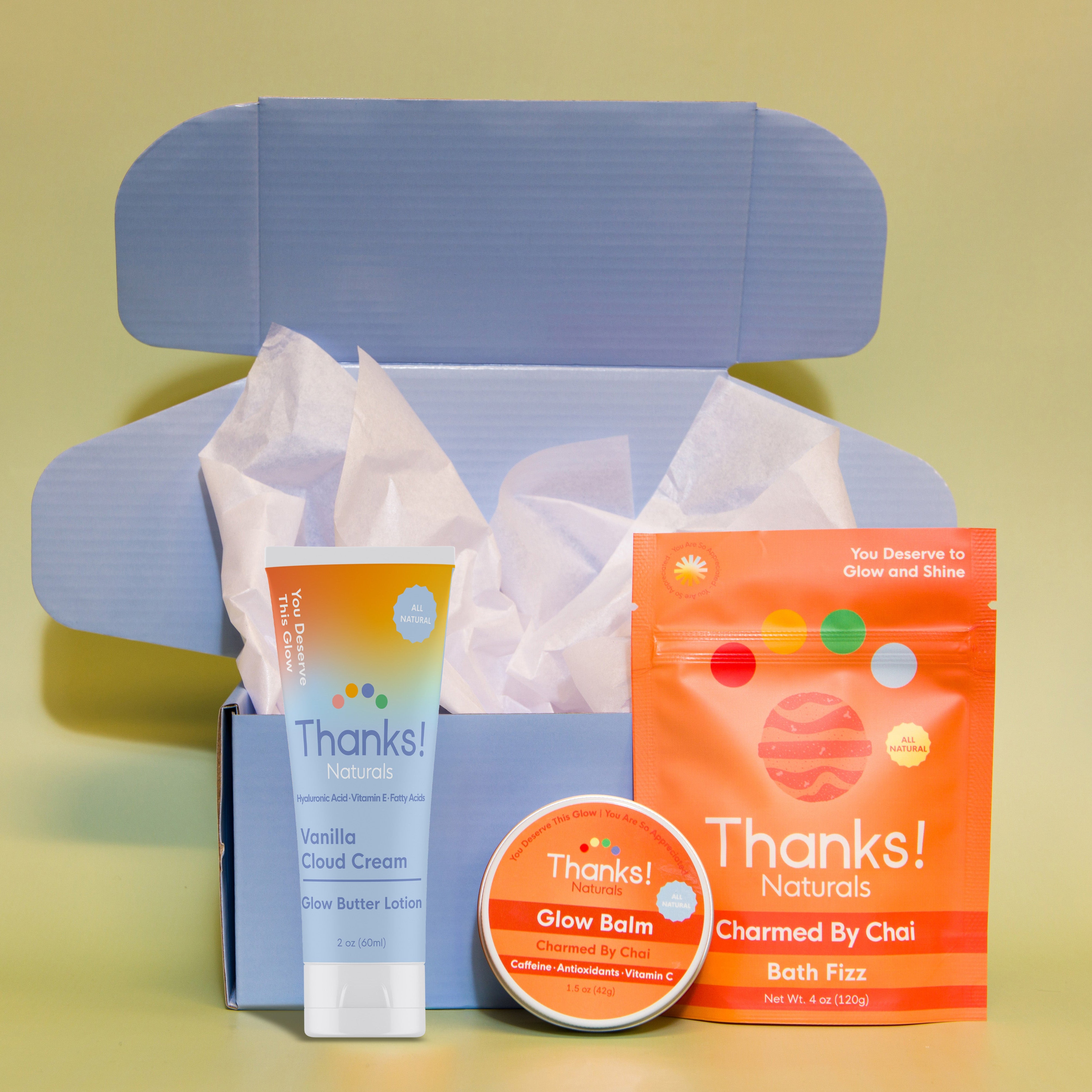 Travel box with Vanilla Cloud Cream Glow Butter Lotion, Charmed by Chai Glow Balm, and Charmed by Chai Bath Fizz — vegan wellness set