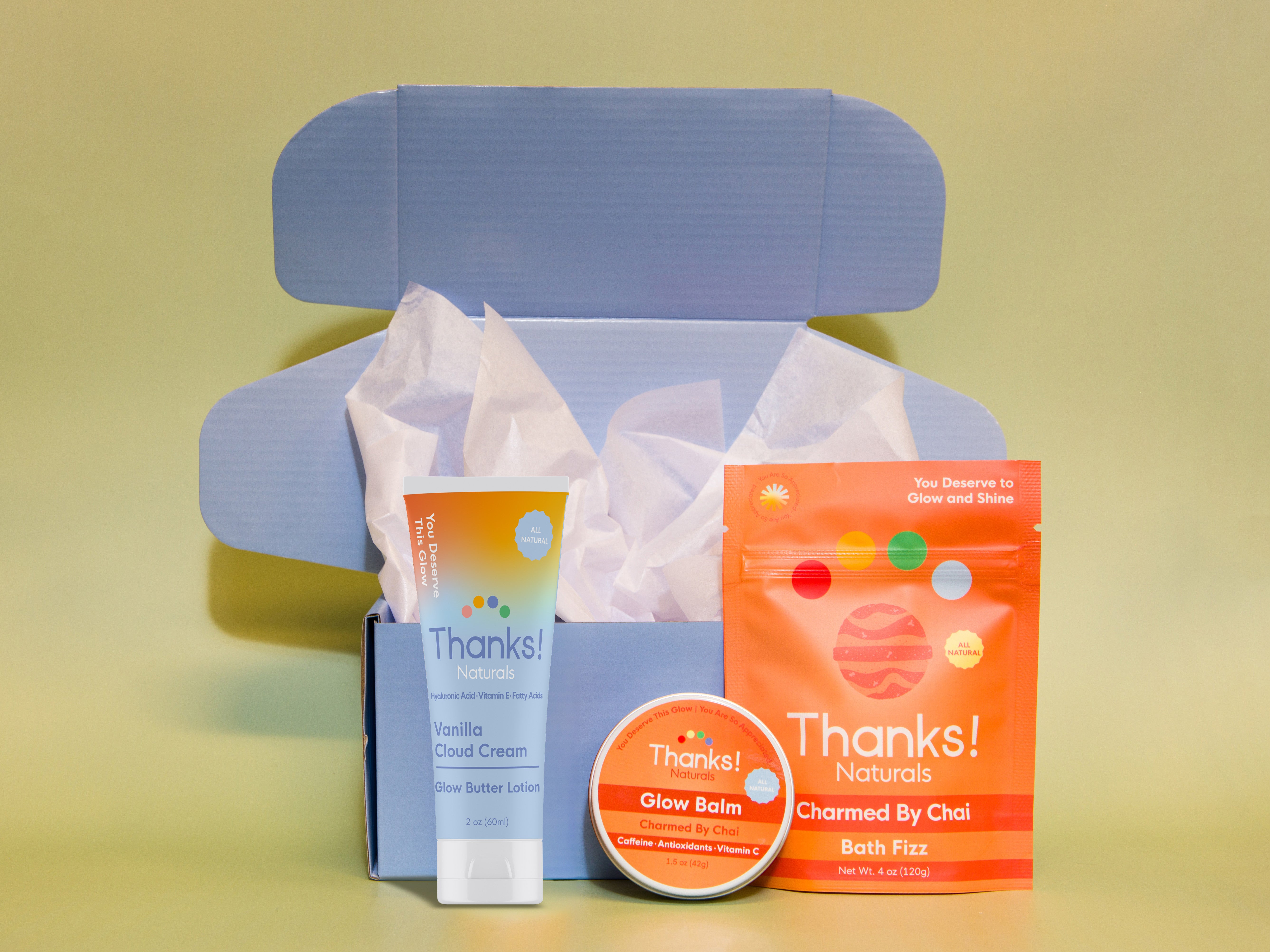 Travel box with Vanilla Cloud Cream Glow Butter Lotion, Charmed by Chai Glow Balm, and Charmed by Chai Bath Fizz — vegan wellness set
